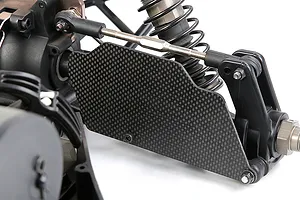 A close-up view of a carbon fibre rear suspension arm guard installed on an RC car chassis.