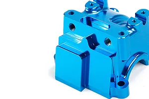A close-up view of a bright blue anodized aluminium RC gearbox case component against a plain white background.