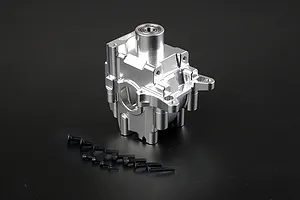 A silver Rovan aluminium gearbox case for an RC car, shown with a set of black mounting screws on a dark background.