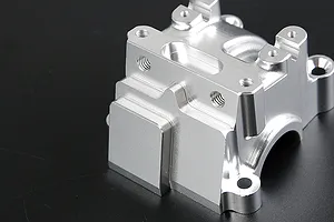 A silver Rovan aluminium gearbox case for an RC car, shown from a high angle against a dark background.