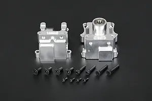 A silver Rovan aluminium gearbox case set with two main housing halves and a collection of black mounting screws on a dark background.