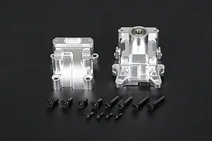 Rovan silver aluminium RC gearbox case halves with a set of black mounting screws on a dark background.