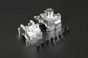 A Rovan silver aluminium gearbox case set with included black screws on a dark background.