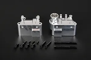 Two silver aluminium RC gearbox case halves with a set of black mounting screws on a black background.