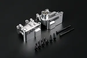 A silver Rovan aluminium gearbox case set for RC cars, including two case halves, a pre-installed bearing, and a collection of black mounting screws.
