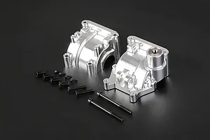 A pair of silver Rovan aluminium gearbox case halves with a set of black mounting screws on a dark background.