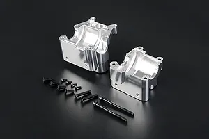 Silver Rovan aluminium gearbox case halves with a set of black mounting screws on a black background.