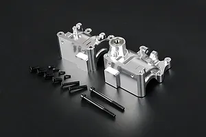 Rovan silver aluminium gearbox case halves with included black screws and bolts on a dark background.