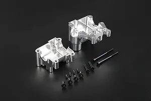 Rovan silver aluminium gearbox case halves and a set of black mounting screws on a dark background.