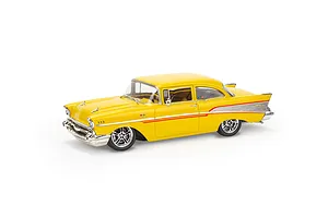 A yellow 1957 Chevrolet Bel Air model car with chrome accents and custom wheels, shown from a high-angle side view against a white background.