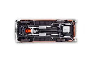 Bottom view of a 1/25 scale 1957 Chevrolet Bel Air model car showing the chassis, engine, exhaust system, and suspension details.
