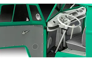 Close-up interior view of a 1/24 scale Revell VW T1 Bus model kit showing the dashboard, steering wheel, and driver side door panel.