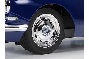Close-up of the front wheel and blue bodywork of a Tamiya Citroen DS RC car kit.