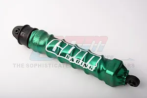 A green GPM Racing shock wrap installed on a black RC shock absorber, featuring a metallic finish and white logo branding.