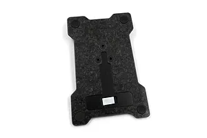 A Yeah Racing carbon fibre base plate for the NB4+ transmitter, featuring a forged carbon pattern, four rubber feet, and a central mounting mechanism.