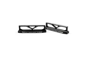 Two black anodized aluminum Yeah Racing droop blocks for RC cars, featuring laser-etched branding and markings on a white background.