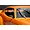 A close-up view of a carbon fiber style side mirror mounted on an orange 1/10 scale RC car body shell.