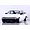 Studio product shot of a white Toyota AE86 Corolla Levin RC car body with black bumpers and custom wheels against a white brick wall background.