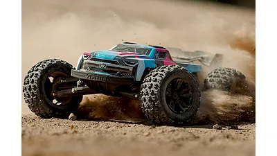 An ARRMA Kraton RC truck driving fast on a dirt track, kicking up a large cloud of dust.