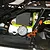 A close-up view of a bright yellow fuel line installed on an HPI Baja RC car engine, connecting the fuel tank to the carburetor.