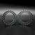 Two grey Reefs RC 1.9 inch aluminium beadlock rings standing upright on a dark surface.