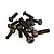 A small pile of black metal socket head cap screws and flat head screws for RC car chassis assembly.