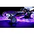 A studio shot of the XRAY XB2'26 1/10 scale 2WD electric RC buggy on a dark background with vibrant purple and blue neon lighting effects.