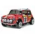 A Tamiya 1/10 scale RC Mini Cooper rally car, painted red with a white roof and numerous racing decals, shown against a plain white background.