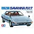 Tamiya 1/24 scale Mazda Savanna RX-7 plastic model kit box art featuring an illustration of a light blue RX-7 with a driver.