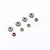 A set of seven small metal portal axle gears of varying sizes arranged on a white background.