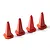 Four small red plastic traffic cones arranged in a row against a white background.