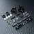 A set of MST black aluminium rear hubs and associated hardware including ball ends, turnbuckles, and spacers on a textured black surface.