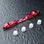 A red anodized aluminium MST adjustable lower suspension arm mount with four small white plastic bushings on a textured black surface.