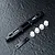 MST black aluminium adjustable lower suspension arm mount with white plastic inserts and a small black metal plate on a textured dark surface.