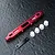 MST red anodized aluminium lower suspension arm mount with white plastic inserts and a black metal plate on a dark textured surface.