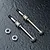 Two MST 42mm lightweight aluminium CVD driveshafts and two ball bearings on a dark textured surface.
