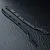 Two black MST RC chassis upper deck rails laid diagonally on a dark textured surface.