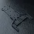 A black MST front lower deck chassis part for an RC car, shown from an overhead angle on a textured black surface.