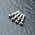 Four silver-colored metal ball studs arranged in a row on a dark, textured surface.