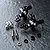 A set of black MST Aluminium ATK V3 steering hubs with included hardware, including ball studs, screws, and spacers on a dark textured surface.