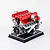 A detailed, assembled Teching DM109 V12 engine model kit featuring red valve covers and intake manifolds mounted on a black display base.