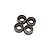 Four small metal shielded ball bearings grouped together on a plain white studio background.