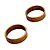 Two copper-coloured metal crush washers displayed against a clean white background.
