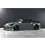 Grey Nissan 350Z RC drift car body shell with black wheels and aero kit displayed on a grey studio floor.