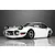 A front three-quarter view of a white Toyota 2000GT RC body shell with pop-up headlights open, parked on a reflective surface.