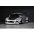 Silver RC drift car body shell styled as a widebody Porsche 911 on a dark surface and background.