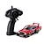 Kyosho First Mini-Z 1982 Nissan Super Silhouette RC car in red and black with matching black pistol-grip transmitter on a white background.