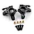 Yeah Racing black aluminium front steering hub carriers with four brass bushings and four screws on a white background.