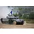 A Russian T-72B3M main battle tank driving through a dusty field with a blue flag and lights mounted on the turret.