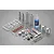 A Tamiya silver aluminium shock absorber kit including metal shock bodies, springs, oil, grease, and various plastic and rubber components on a grey background.